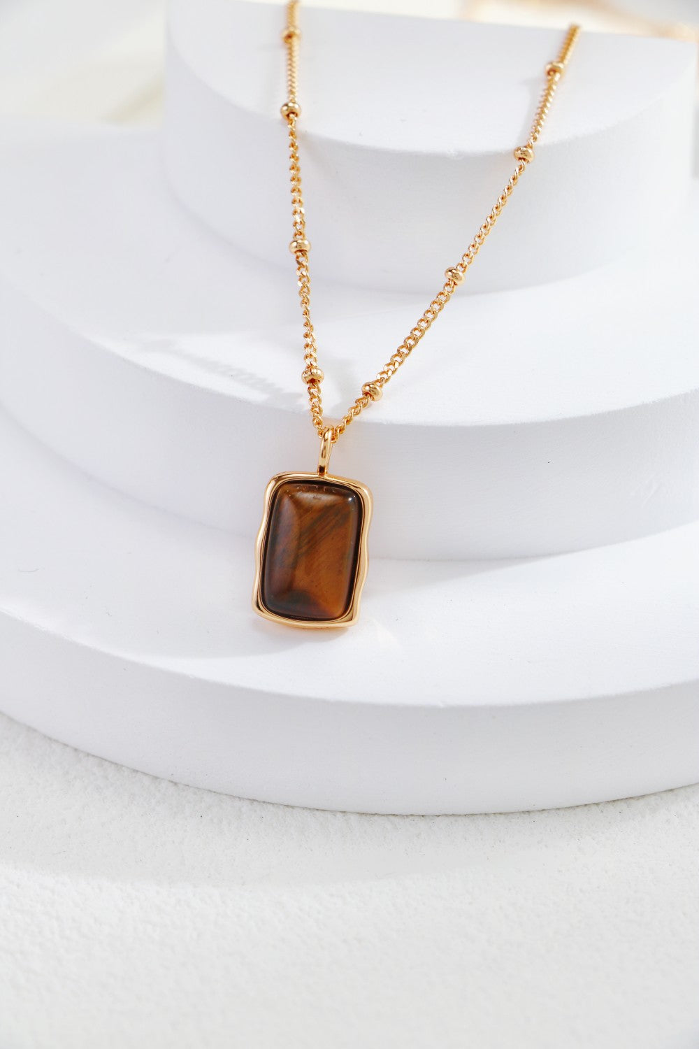 the medium length necklace has a square shape tiger eye stone pendant, easy to wear it solo or layering. the necklace is 18k gold plate sterling silver