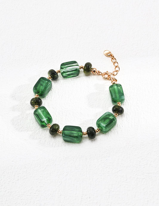 this green resin bracelet is bold and attractive, made of translucent square and round beads, like candy on your wrist. adjustable to your size. 