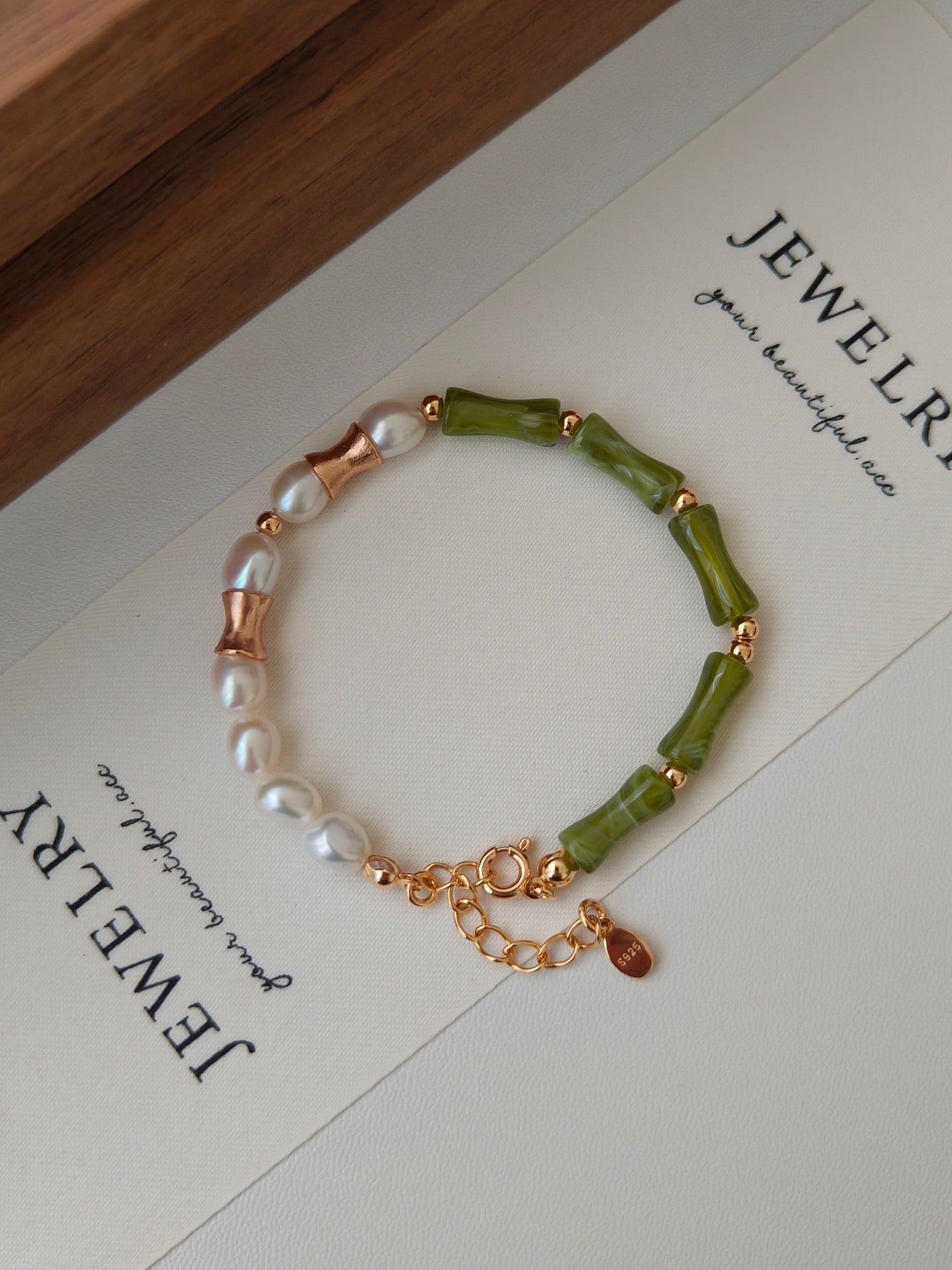 natural pearl mix with green resin, the bamboo shape resin represents life is getting better, the asymmetric design made this bracelet unique