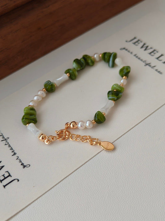 mixed elegant small pieces of green resin stones and white shells, adjustable length makes the bracelet fit all. 18k gold plated sterling silver.